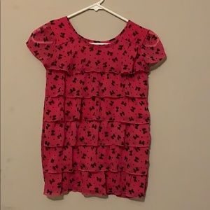 Dark pink blouse with black bows on it